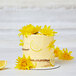 A cake with yellow flowers and lemon slices with Rich's Bettercreme Lemon Whipped Icing.