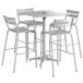 A Lancaster Table & Seating bar height outdoor table with 4 barstools and an umbrella hole.