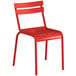 A red metal Lancaster Table & Seating outdoor chair.