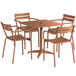 A Lancaster Table & Seating brown aluminum dining table with a black top and 4 chairs on an outdoor patio.