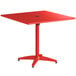 A red square Lancaster Table & Seating outdoor table with a metal base.