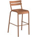 A brown barstool with a white back.