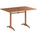 A brown rectangular Lancaster Table & Seating outdoor table with a metal base and legs.