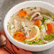 A bowl of College Inn chicken soup with carrots and celery.
