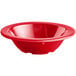 An Acopa Foundations red melamine fruit bowl with a white background.