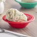 A close-up of a red Acopa Foundations melamine bowl filled with ice cream.