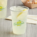 A clear plastic cup filled with ice-cold lemonade and a lemon slice, featuring a printed 'Lemonade' logo on the front.