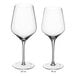 Two Della Luce Astro wine glasses with measurements on them.