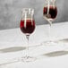 Two Della Luce Maia dessert wine glasses on a marble table.