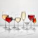 A group of Della Luce Maia burgundy wine glasses on a white background.