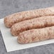 Warrington Farm Meats country sausage links on a white surface.