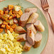 A plate of Warrington Farm Meats turkey sausage links with potatoes and eggs.