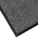 A gray carpet mat with black trim.