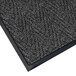 A black Lavex Chevron Rib entrance mat with a gray border.