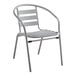 A gray metal Lancaster Table & Seating outdoor arm chair.
