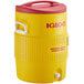 A yellow Igloo insulated beverage dispenser with a red lid.