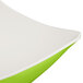 A white melamine bowl with a lime green interior and flared edges.