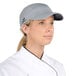 A woman chef wearing a gray Headsweats 5-panel cap with a terry sweatband.