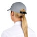 A woman wearing a gray Headsweats 5-panel cap with a ponytail.