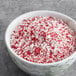 A bowl of crushed red and white peppermint candy crystals.