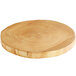 A Front of the House ROOT natural wood serving board with a circular pattern on the edge.