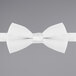 A close-up of a white Henry Segal bow tie with an adjustable band.