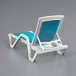 A white chaise lounge with a turquoise sling seat.