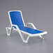 A white chaise lounge chair with a marine blue sling seat.