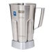 A stainless steel pitcher with a handle.