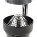 A Hamilton Beach stainless steel citrus juicer with a metal strainer.