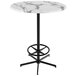 A round white marble Holland Bar Table with a black base.