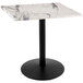 A white marble Holland Bar Stool outdoor counter height table with a black base.