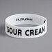A white wristband with black text that says "Sour Cream"