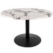 A white marble round table top with a black round base.