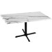 A white marble table with a black cross base.