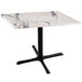 A white marble table with a black cross base.