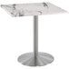A white marble table with a silver metal base.