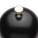 A black round object with a silver knob.
