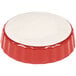A red and white fluted china quiche dish.