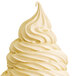 A white soft serve swirl on a large ice cream cone.