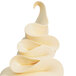 A close-up of a swirly white frosting from a Carpigiani soft serve machine nozzle.