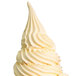 A white soft serve ice cream cone with a swirl on top.