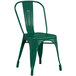 A green Lancaster Table & Seating outdoor cafe chair.