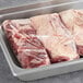 A tray with two pieces of Warrington Farm Meats boneless beef short ribs.