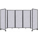 A Versare marble gray SoundSorb folding room divider with four panels on wheels.
