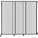 A clear poly wall-mounted sliding room divider with black and white panels.