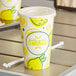 A Carnival King paper lemonade cup with lemons on it.