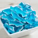 A white bowl filled with Vidal Gummy Sharks.
