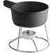 A black Valor pre-seasoned cast iron fondue pot on a stand.