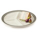 A white GET Diamond Cambridge melamine plate with meat and grapes on it.